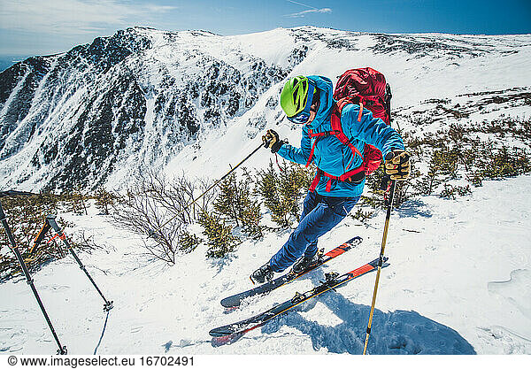 Backcountry skier clipping in above Tuckerman Ravine  NH