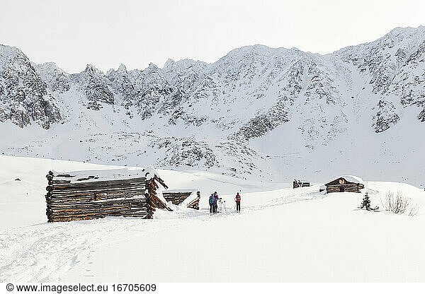 Backcountry skiers outside mine ruins in Mayflower Gulch  Colorado