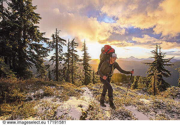 Backpacker enjoy the mountain view during sunet.