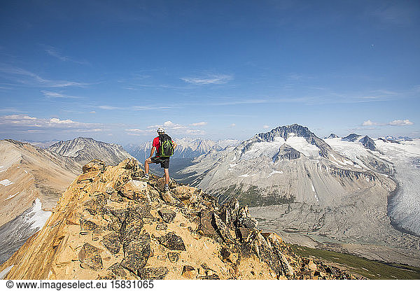 Backpacker standing on mountain summit.