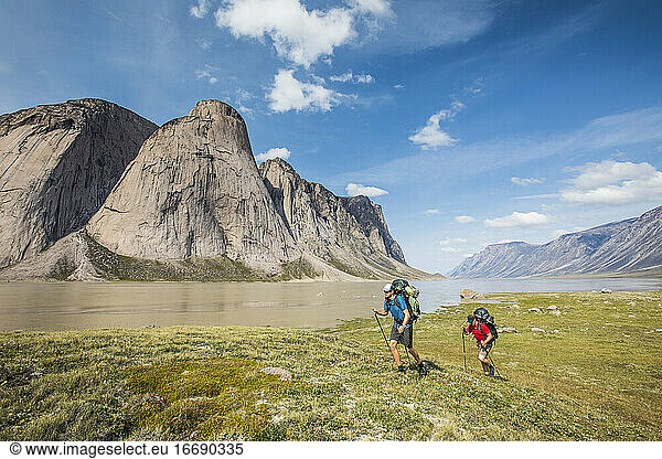 Backpackers hike over arctic tundra in Akshayak Pass