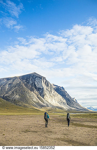 Backpackers hiking through Akshayak Pass  Baffin Island  Canada.