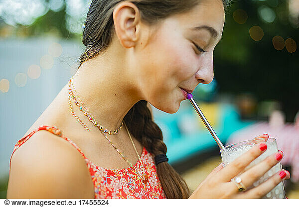 Backyard portrait of of girl drinking a milkshake