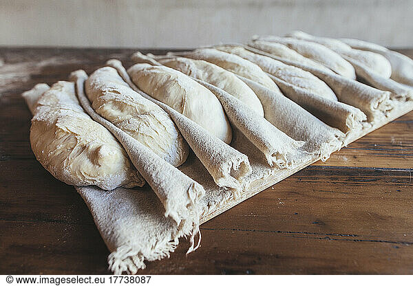 Baguette dough arranged on napkin in bakery