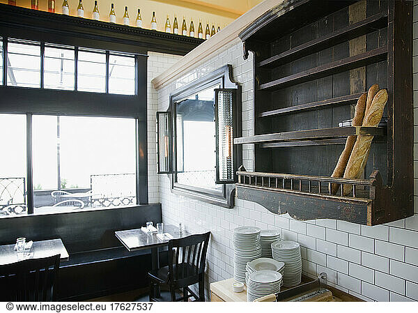 Baguettes in wooden wall rack at French Restaurant.