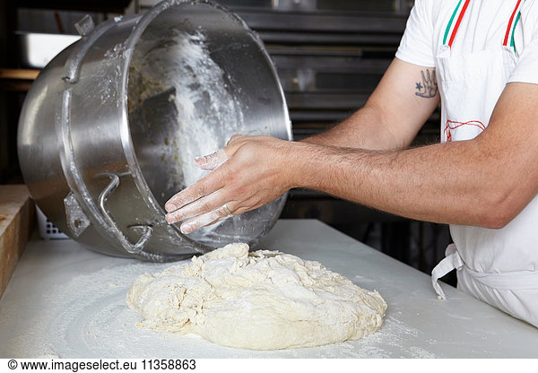 Baker in bakery  making bread