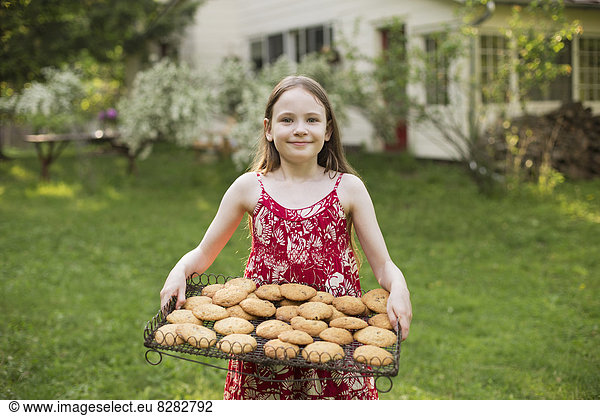 Baking Homemade Cookies. A Young Girl Holding A Tray Of Fresh Baked Cookies.