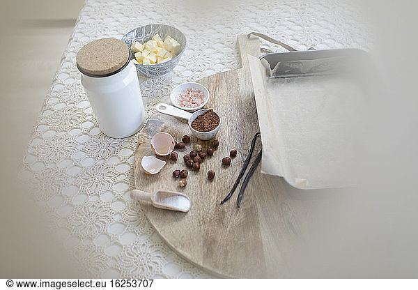 Baking ingredients on cutting board and table