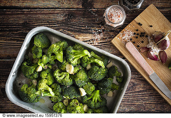 Baking pan with chopped broccoli and garlic