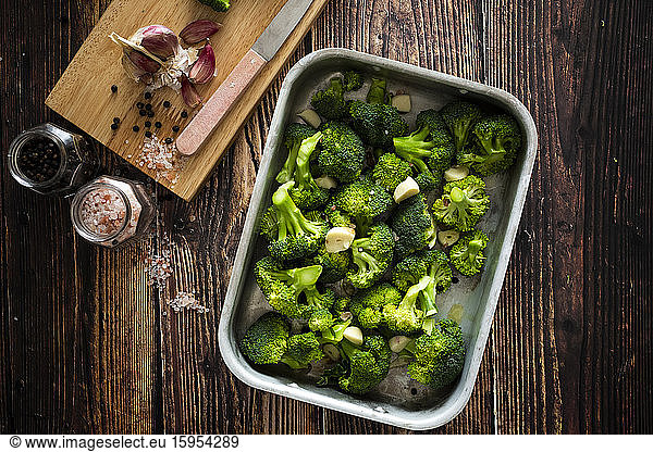 Baking pan with chopped broccoli and garlic