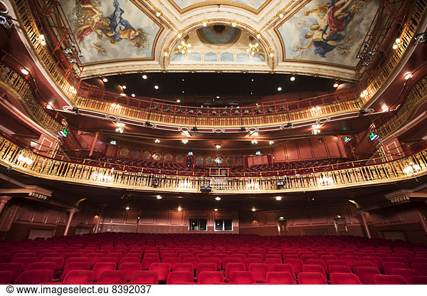 Balcony  seats and ornate ceiling in theater auditorium