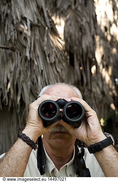 Balding Elderly Man With Moustache Looking Through Binoculars