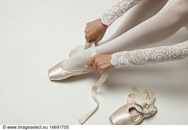 ballerina Putting On Ballet Shoes