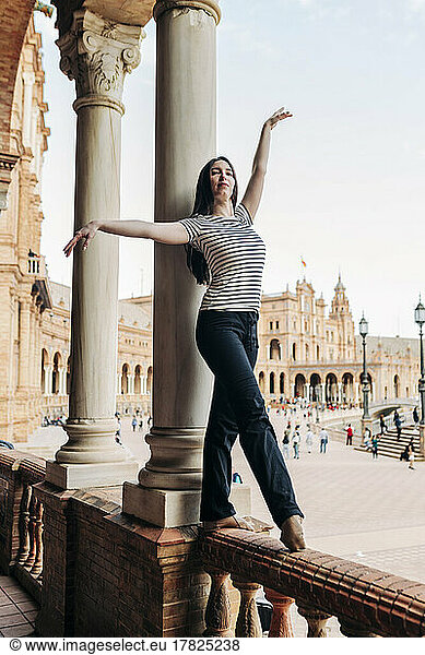 Ballet dancer balancing on historic railing