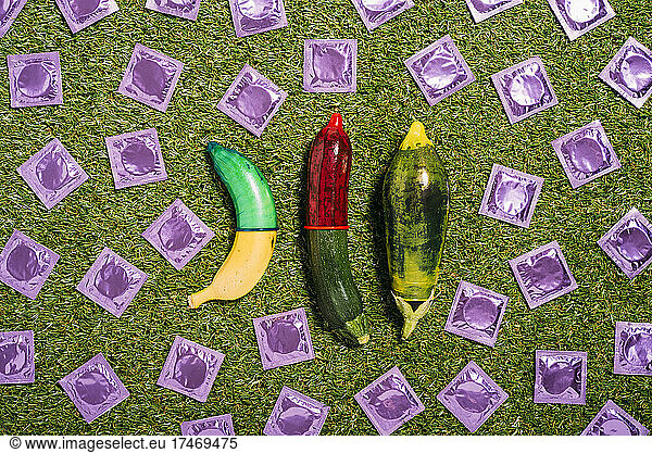 Banana and vegetables with condoms on grass