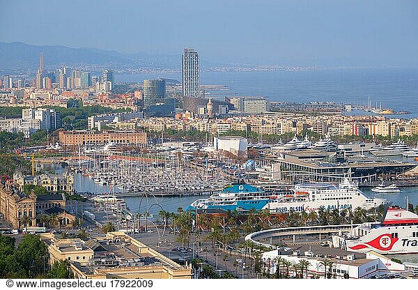 BARCELONA  SPAIN  APRIL 15  2019: Aerial view of Barcelona city skyline with city traffic and port with yachts and ferry ships. Barcelona  Spain  Europe