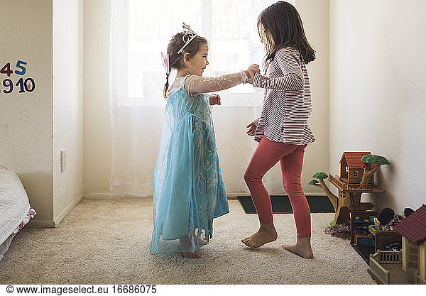 Barefoot 6 yr old dancing with 4 yr old sister in princess costume