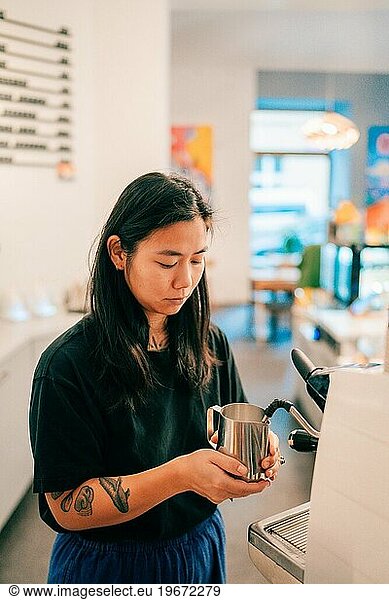 Barista girl preparing coffee in a cafe