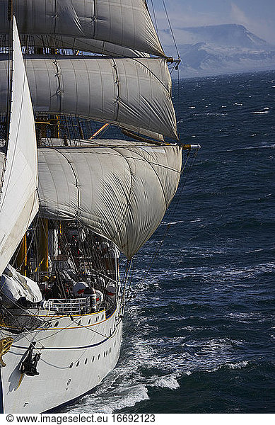 barque under full sails in bad weather in Iceland