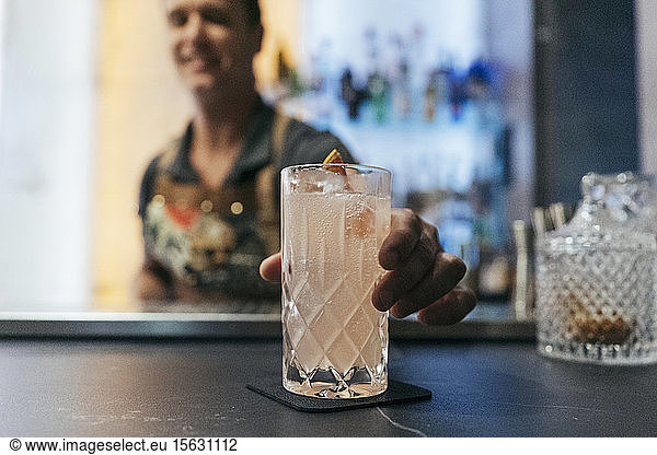 Bartender mixing cocktail in a bar  cocktail glass