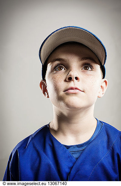 Baseball player looking away against white background