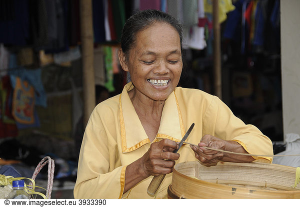 Basket maker producing baskets for farmers at a weekly market near Yogyakarta  Central Java  Indonesia  Southeast Asia