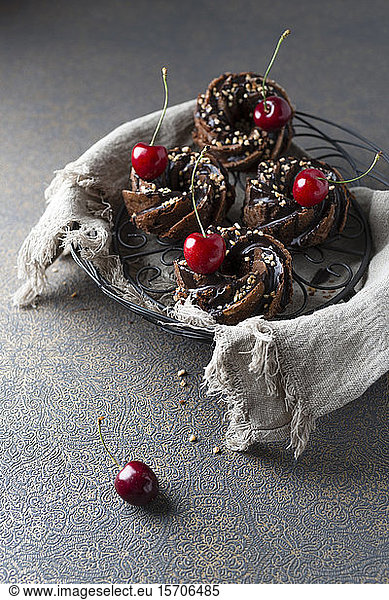 Basket of German minigugelhupf cakes with chocolate brittle and cherries