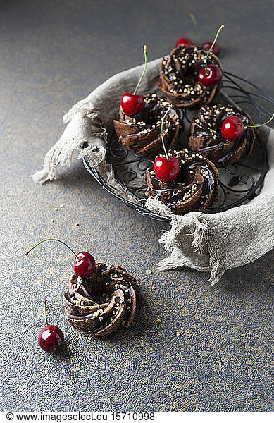 Basket of German minigugelhupf cakes with chocolate  brittle and cherries
