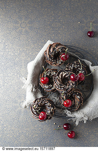 Basket of German minigugelhupf cakes with chocolate  brittle and cherries