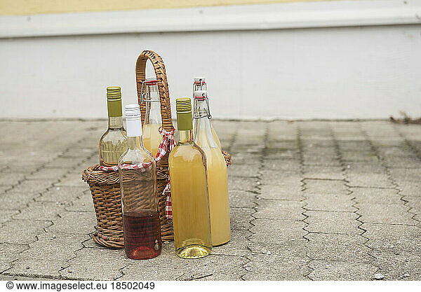 Basket with apple juice and rose wine  Bavaria  Germany