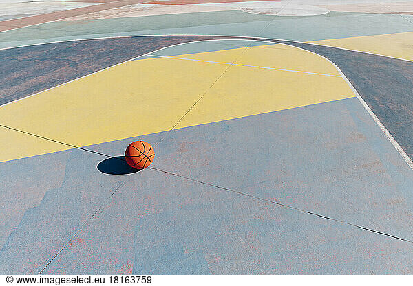 Basketball on sports court at sunny day