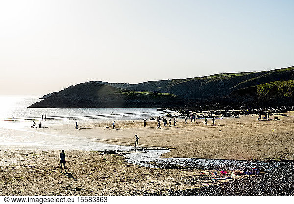 Bathers on a sandy beach on the Pembrokeshire Coast  Wales  UK.