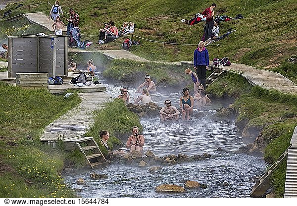 Bathing people in the hot thermal springs Reykjadalur  geothermal area  near Hveragerdi  southern Iceland  Iceland  Europe