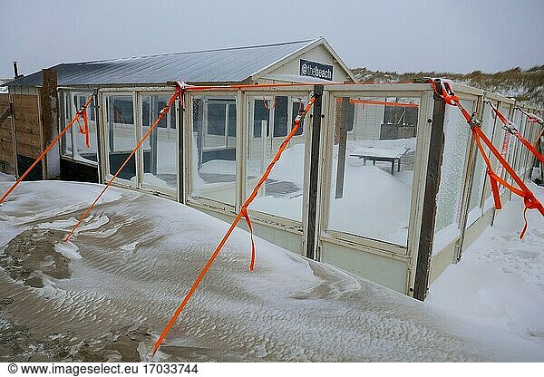 Beach house in the snow in a blizzard at the beach in Den Haag  Holland