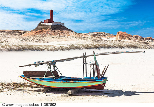 Beached fishing boat and lighthouse  Fortim  Ceara  Brazil