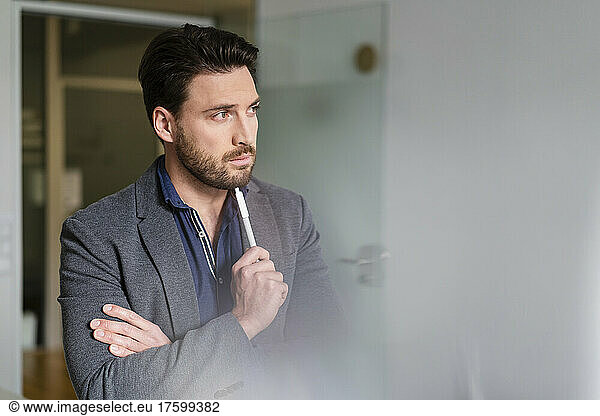 Bearded businessman thinking in office