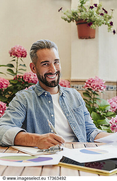 Bearded male professional working on business plan at desk