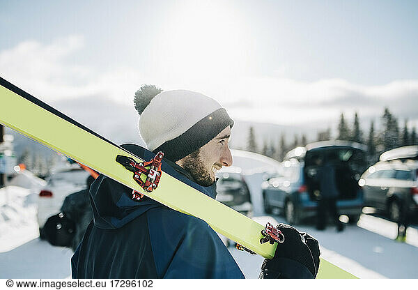 Bearded man with ski on sunny day during winter