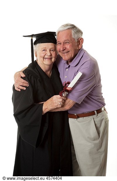 Beauitiful Caucasian woman in a black graduation gown with her husband