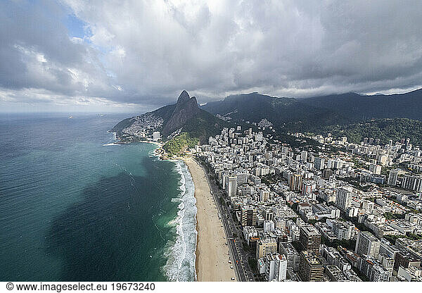 Beautiful aerial view to ocean beach and city buildings in Rio