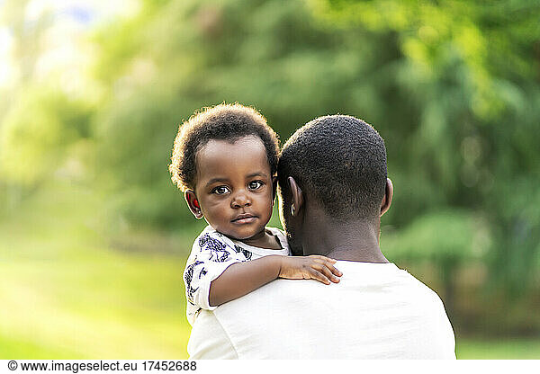 beautiful African girl hugging her father