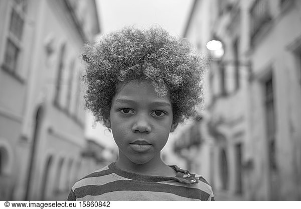 Beautiful Afro-Brazilian boy with curly hair in the streets