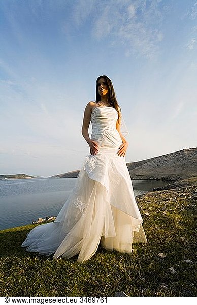 Beautiful bride standing in late afternoon light