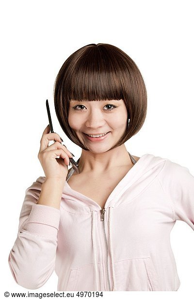 Beautiful Chinese woman using a cell phone on a white background