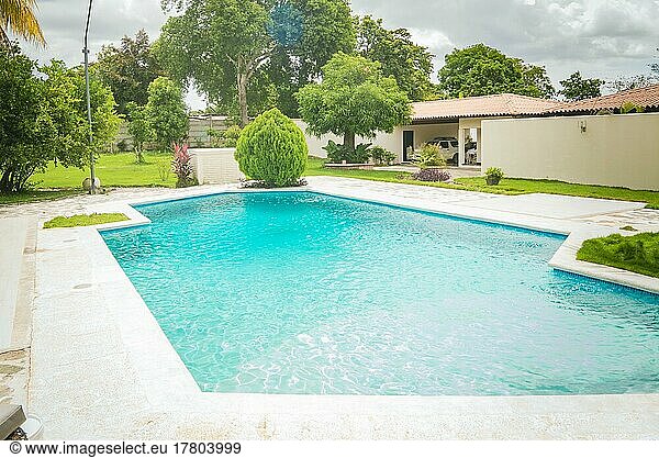 Beautiful crystal clear home pool. A crystal clear home swimming pool on a sunny day  Concept of home swimming pool designs