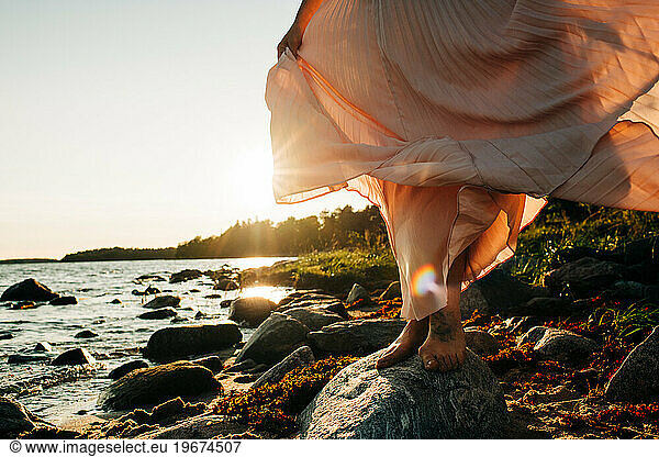 beautiful dress floating in the wind at sunset at the beach