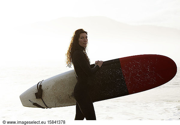 Beautiful  fit surfer girl in the Pacific Northwest