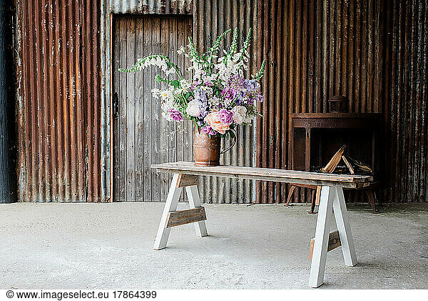 beautiful flowers on a bench in a barn ready to photograph for a shoot