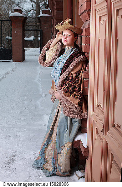 Beautiful Russian woman in a vintage dress. Russian village. Winter.