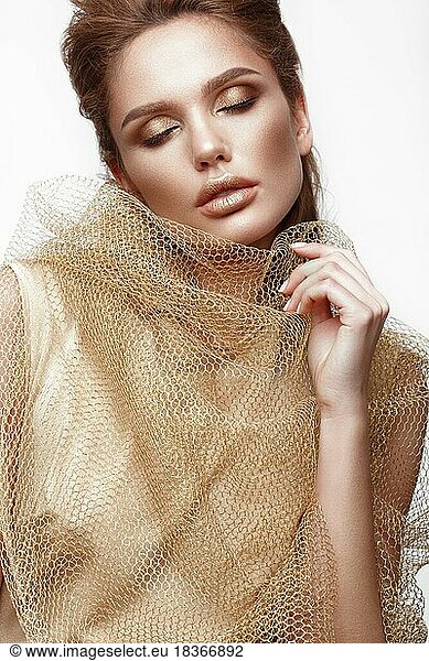 Beautiful sexy girl with sensual lips  fashion hair  gold dress and accessories. Beauty face. Picture taken in the studio